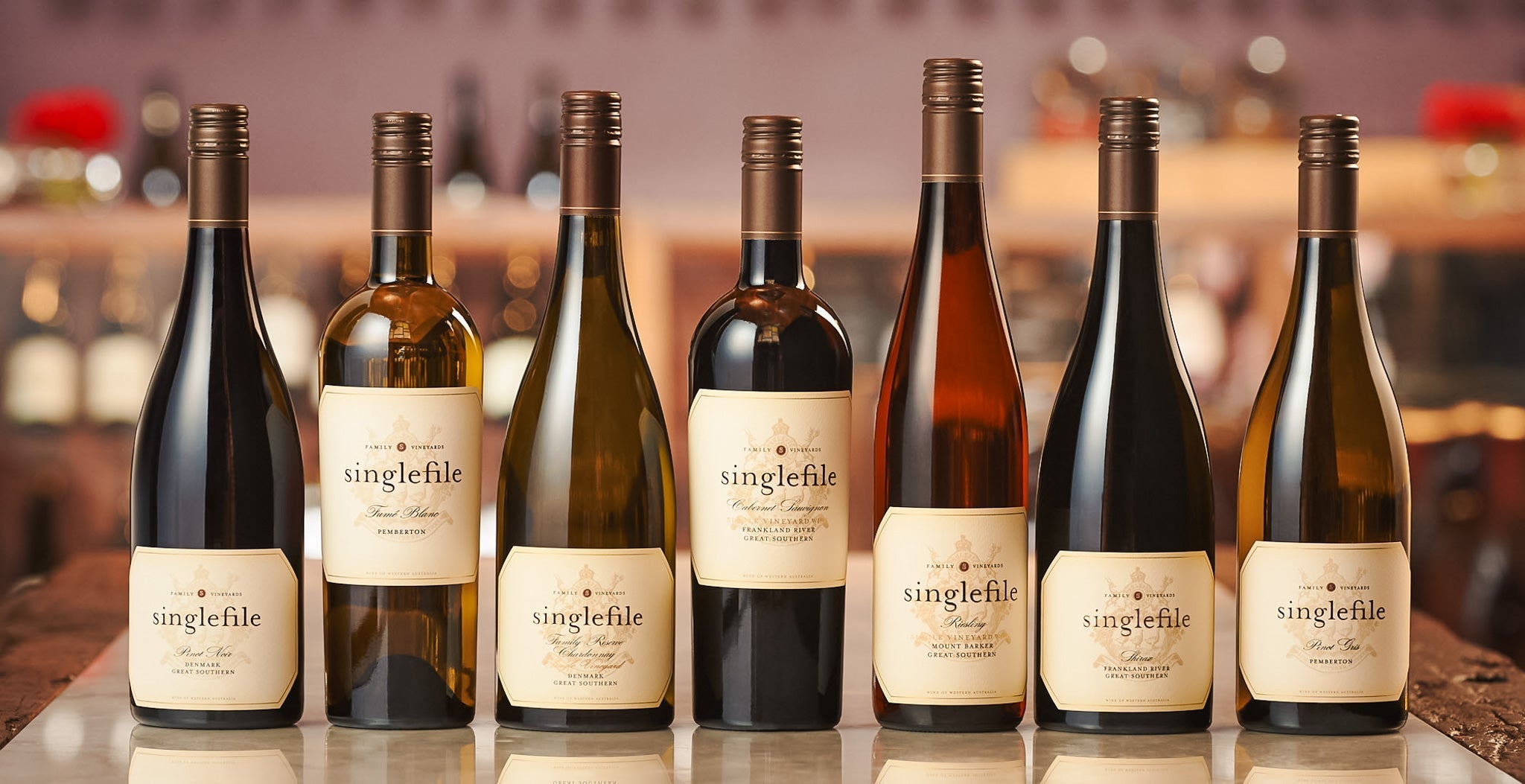 A lineup of different shaped Singlefile wine bottles