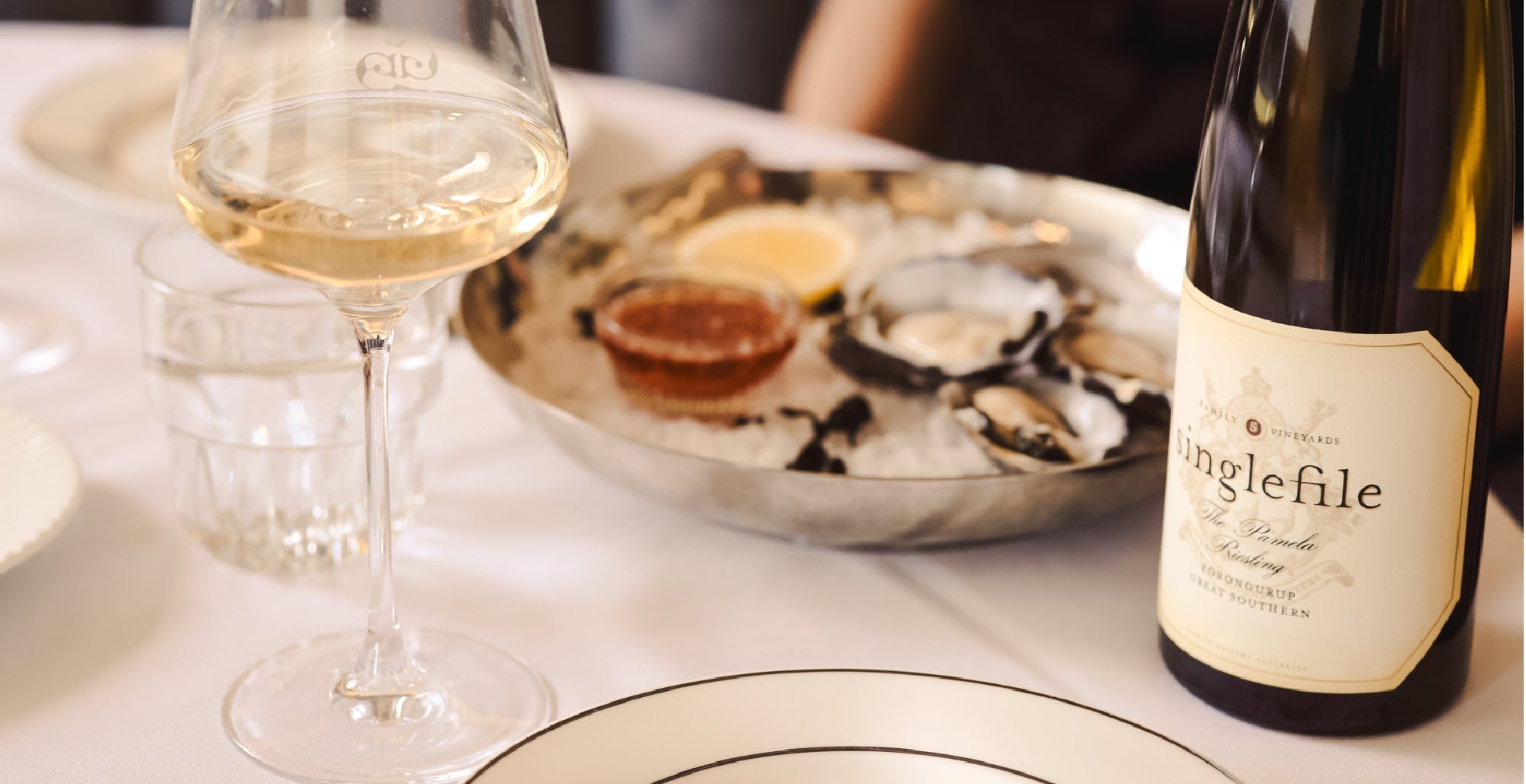 Bottle and glass of Singlefile Great Southern riesling served with fresh oysters