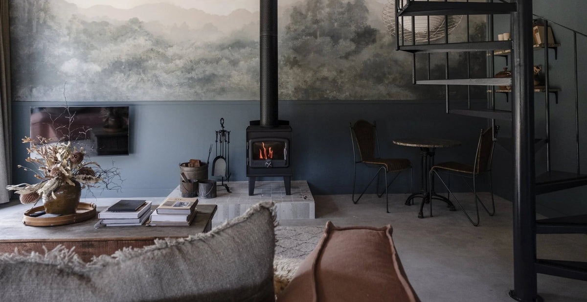 A lounge room with a wood fire at a Denmark accommodation property, Western Australia