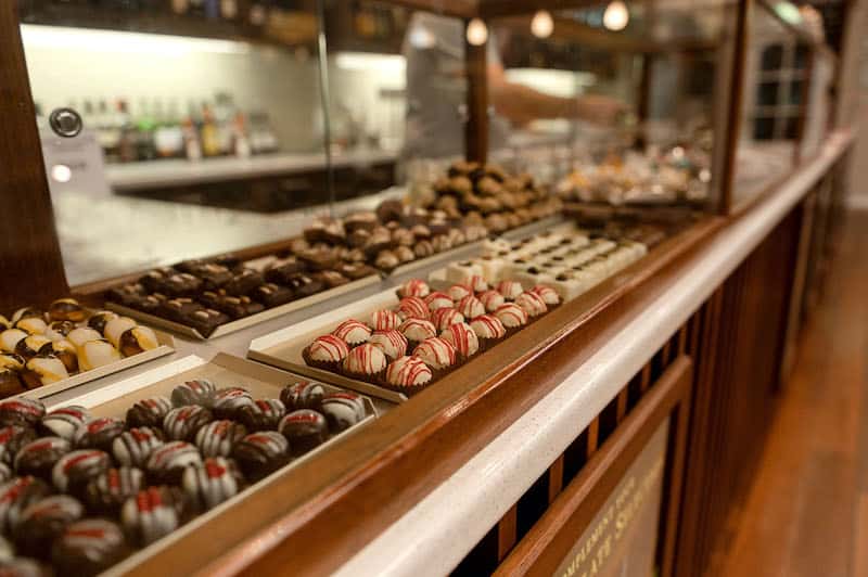 Display case with various types of chocolates in a store setting