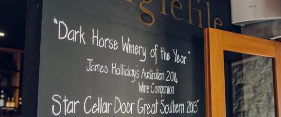 Chalkboard with wine recommendations and awards at a winery.