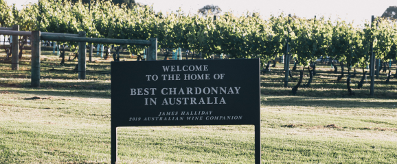 Sign welcoming visitors to the home of best Chardonnay in Australia in a vineyard setting.