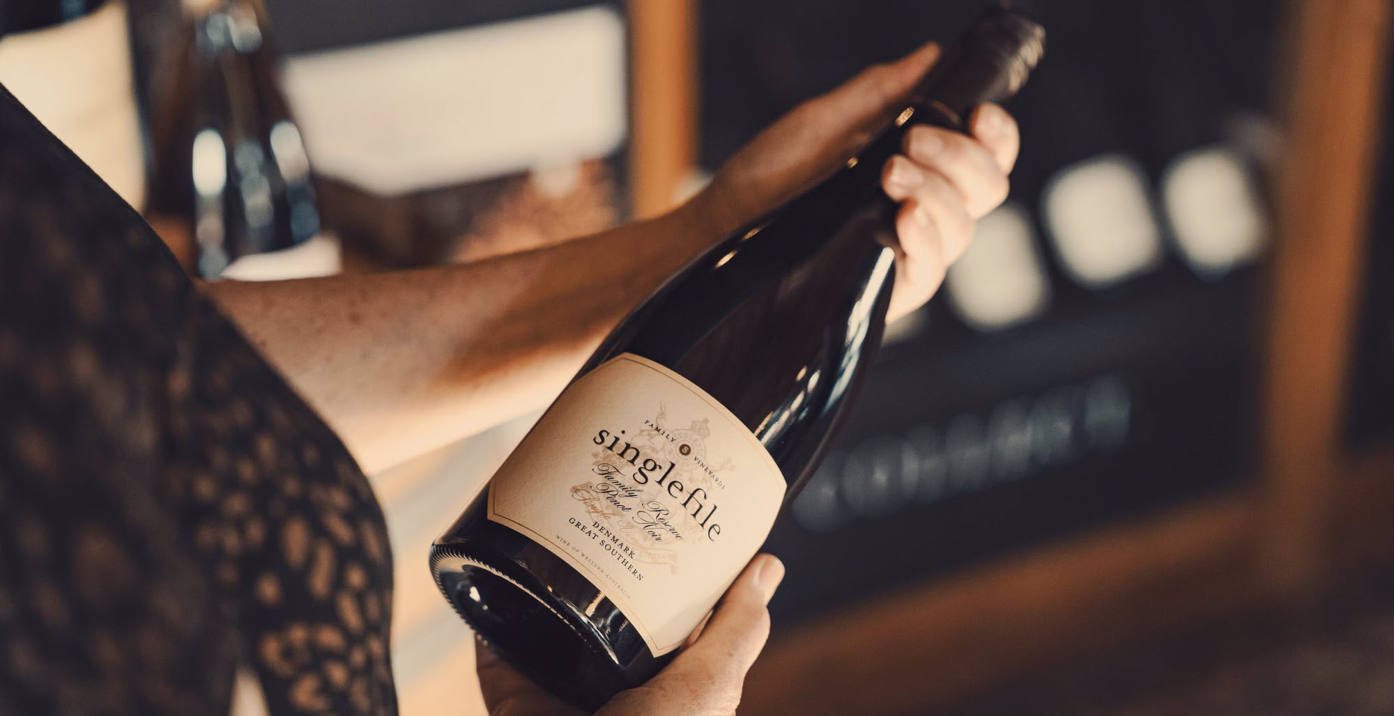 Hands holding a bottle of Family Reserve Pinot Noir