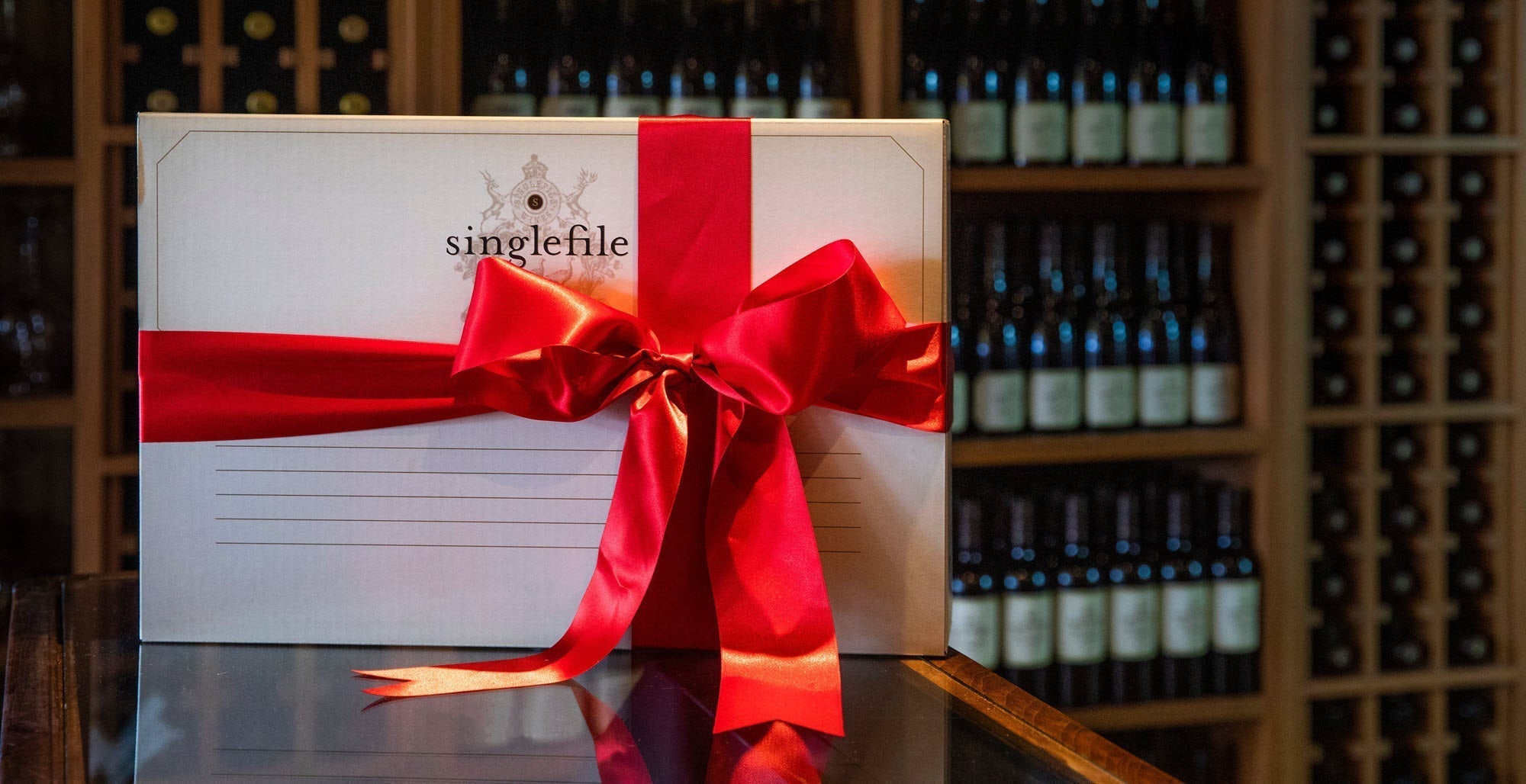 A box of Singlefile wine with a large red bow