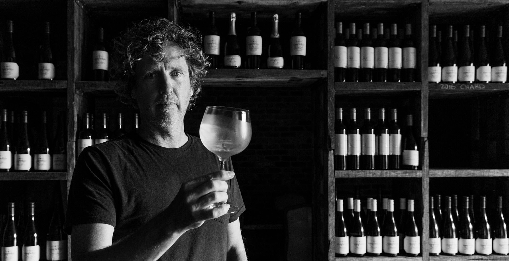 Patrick Corbett swirling a glass of Chardonnay in the Singlefile private tasting room