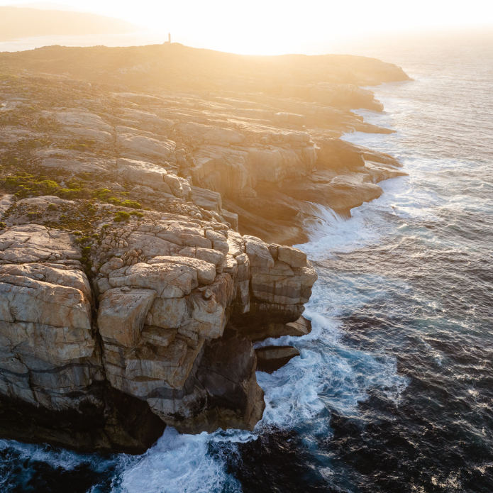 Landscape of rock formations and water plashing against the rocks
