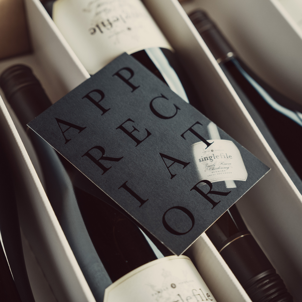 Wine bottles with a card labeled 'Appreciator' on top