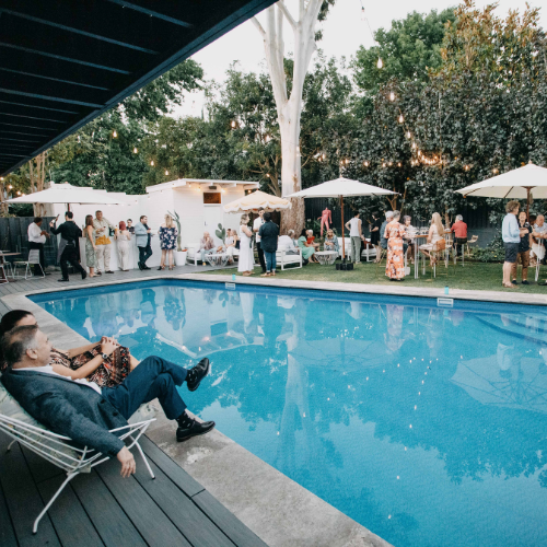 Group of people partying by a pool
