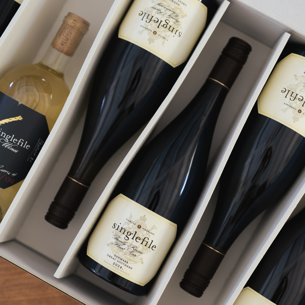 Three bottles of Singlefile wine in a box with visible labels.