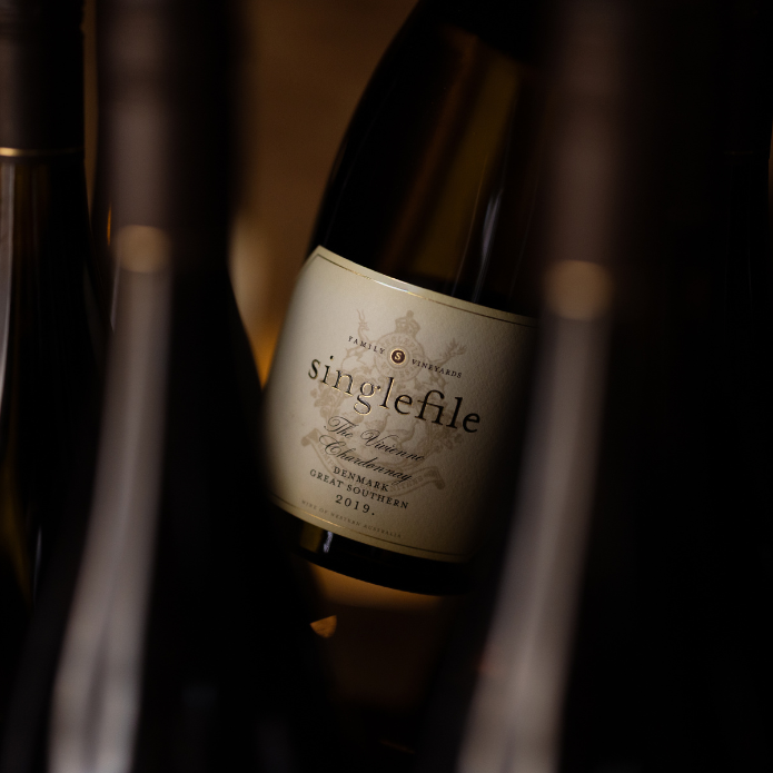 Wine bottle labeled 'singlefile' with blurred background