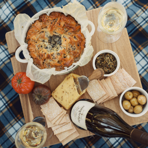Image of a pie and spread with white wine