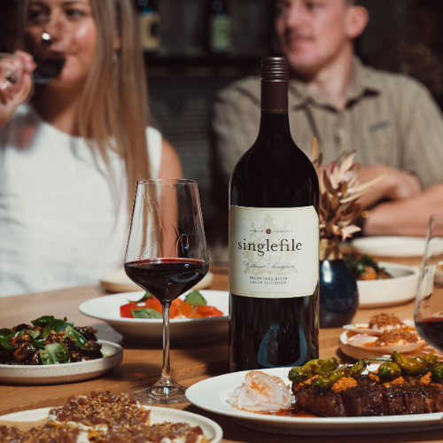 Three magnum bottles of wine on tree stump