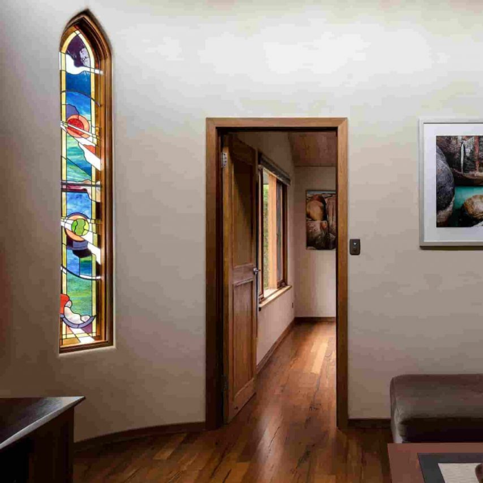 Stained glass window in a room with wooden floor and door