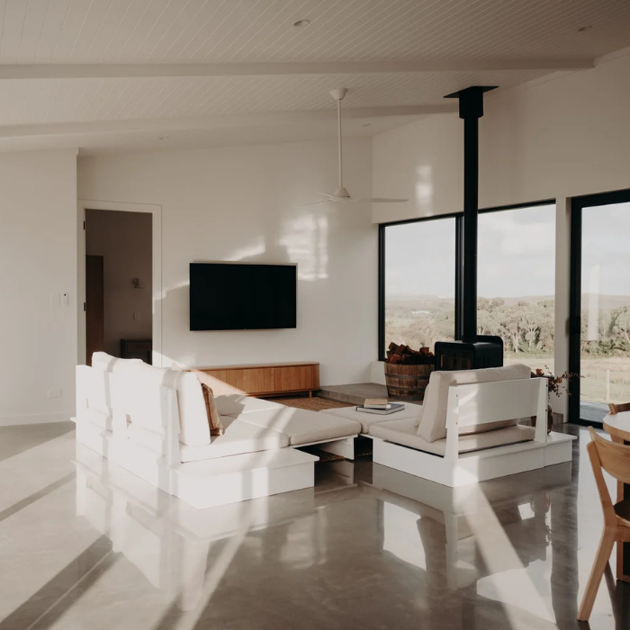 Modern living room with white furniture and large windows
